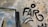 Graffiti on a concrete wall featuring the word 'FARO' in bold black letters. The background shows weathered, peeling paint with hints of yellow, blue, and beige. Various lines and shapes surround the text, adding an abstract element to the street art.