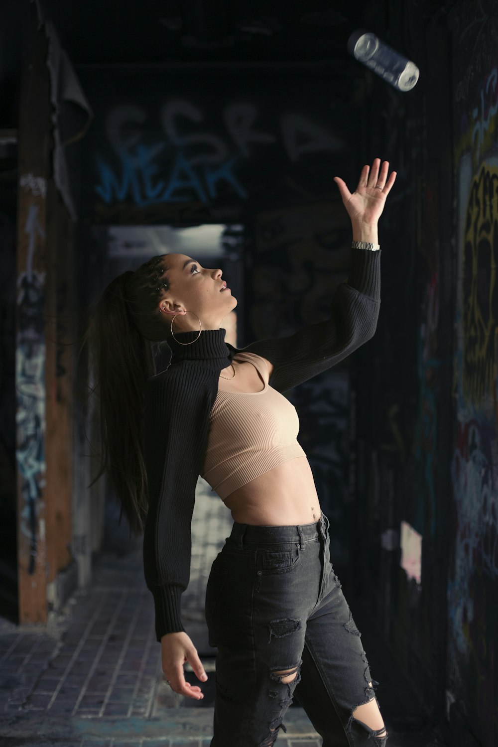 Woman in brown sports bra and black denim jeans standing and raising her  right hand photo – Free Fashion Image on Unsplash