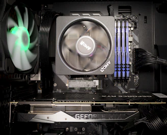 A set of computer components including a motherboard, RAM, and graphics card.
