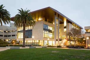white and brown concrete building near palm trees during daytime