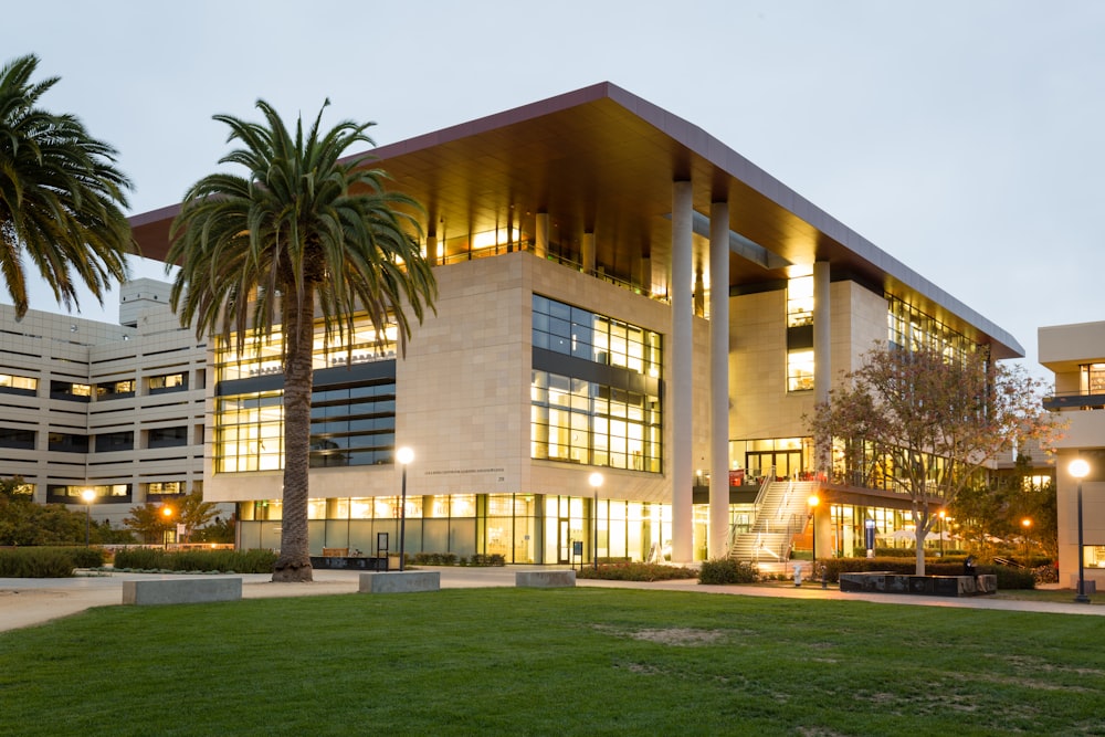 white and brown concrete building near palm trees during daytime