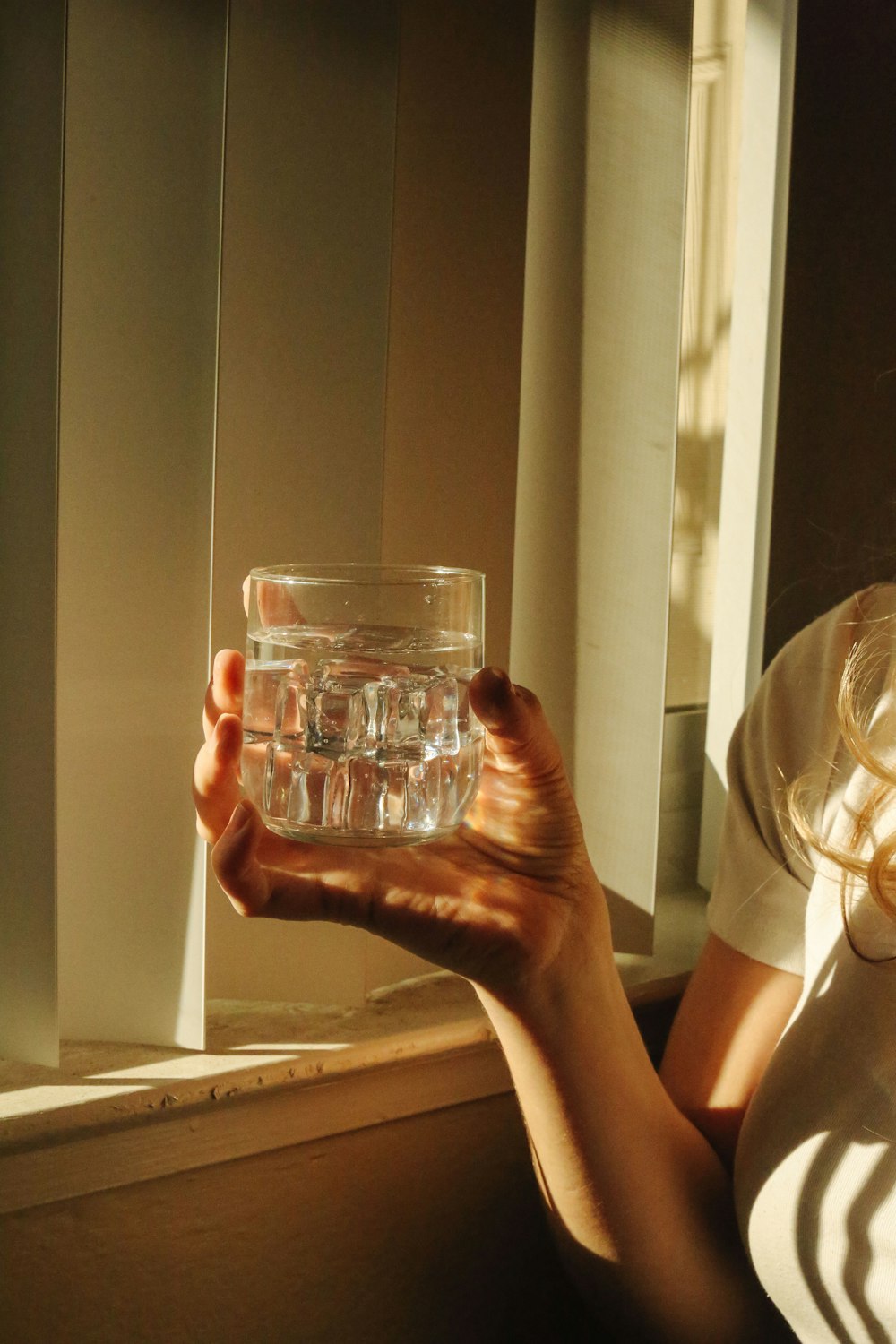 person holding clear drinking glass