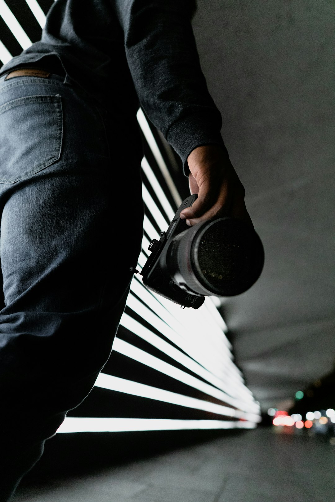 person in black denim jeans and black and white striped long sleeve shirt