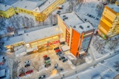 Aerial view of a well-maintained commercial property with landscaping and snow removal.
