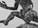 A close-up of a detailed bronze sculpture depicting a human figure in a dynamic pose.