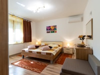 white and brown bed near brown wooden table