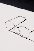 silver framed eyeglasses on white table