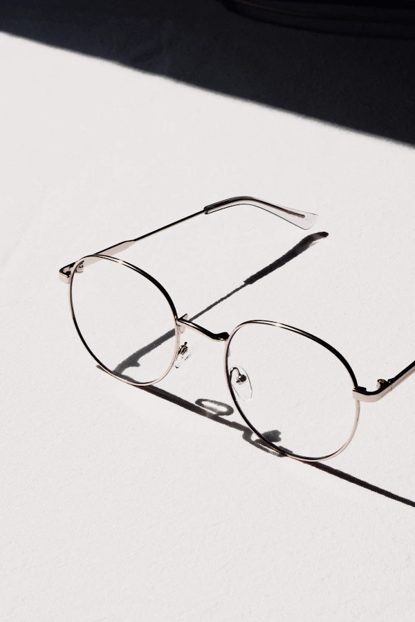 Silver-framed eyeglasses on a white table