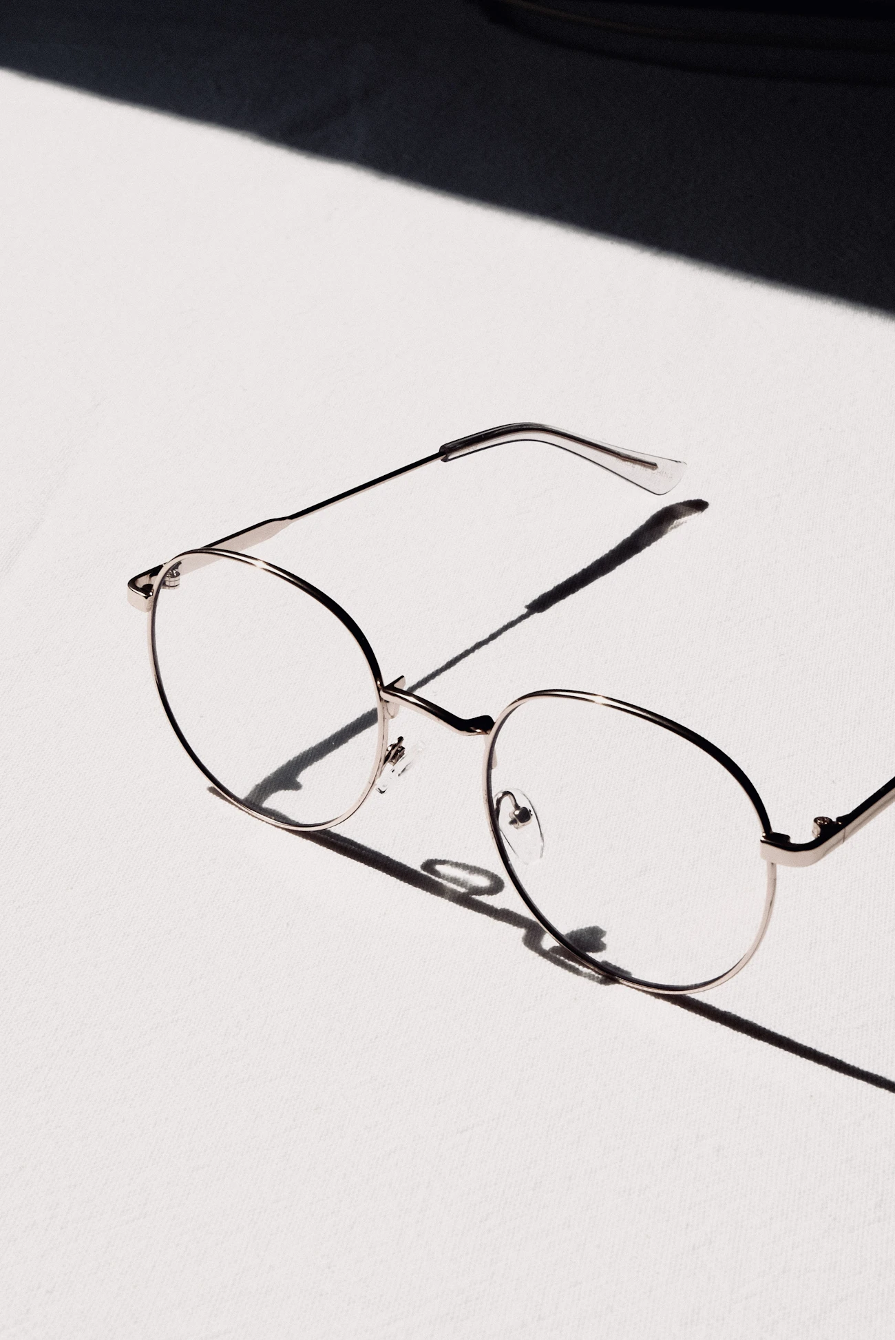 A wall display of designer eyeglass frames in a modern optical shop