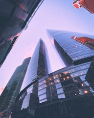 Sleek high-rise with panoramic city views under a sky painted with aurora lights.