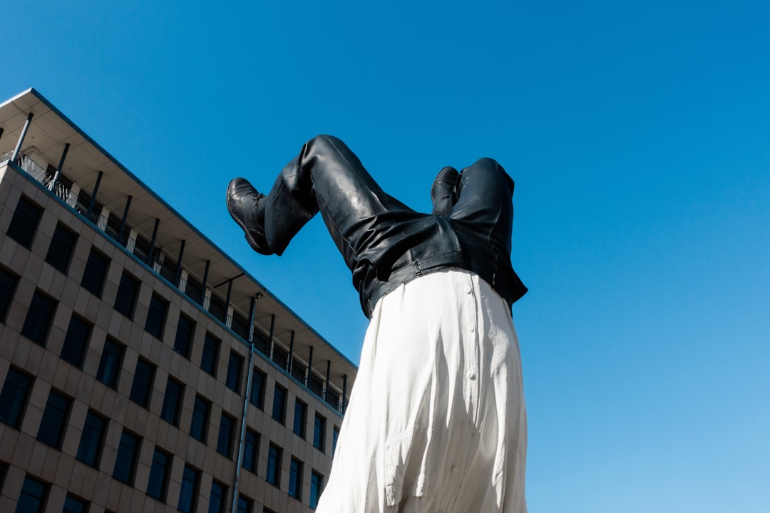 man in white dress shirt and pants statue