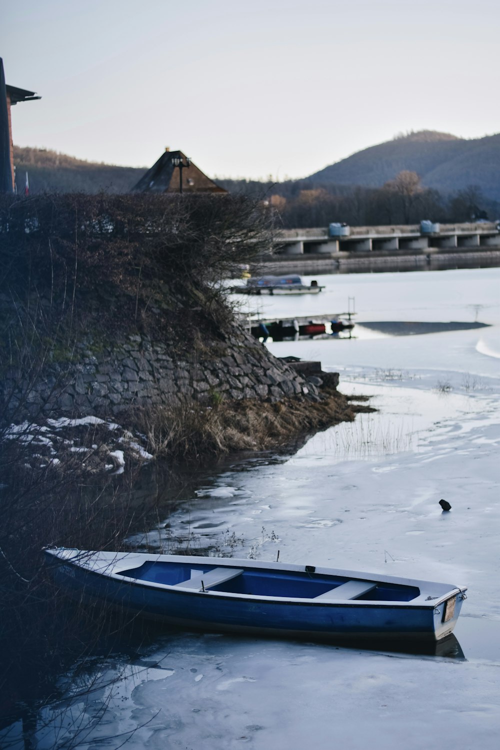 white and blue boat on water