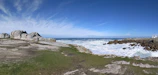 A scenic view of a Welsh coastline with Cytara's lab building in the background.