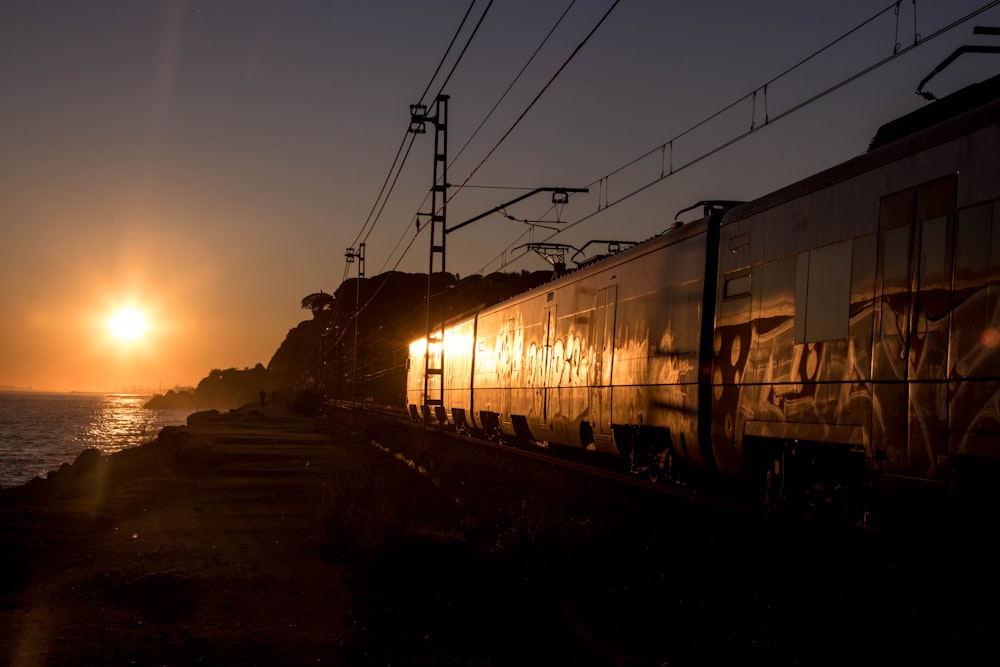 train on rail during sunset