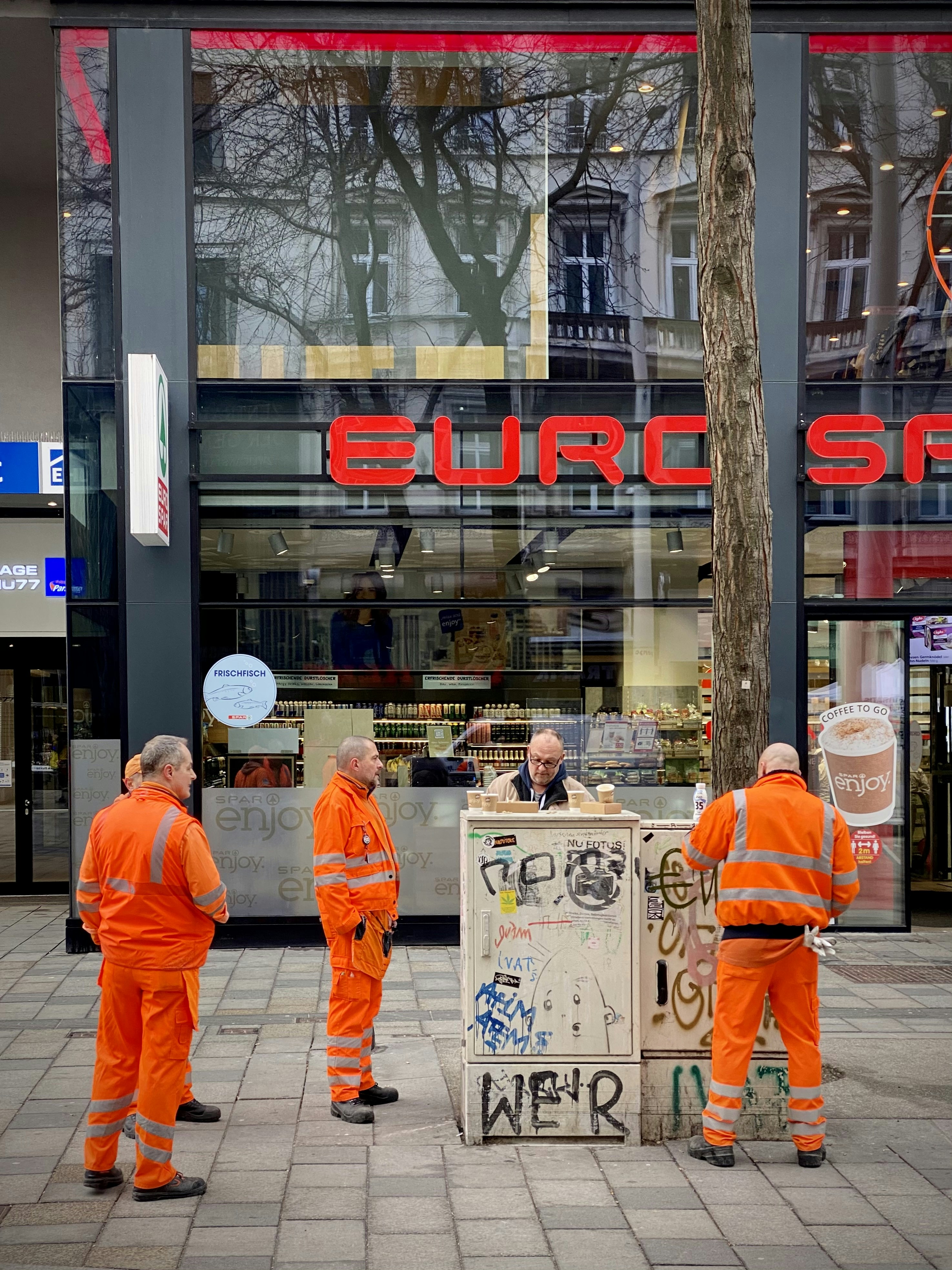 2 men in orange robe walking on sidewalk during daytime