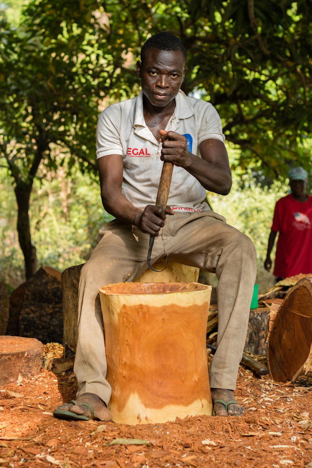 man in white crew neck t-shirt holding brown and black power tool