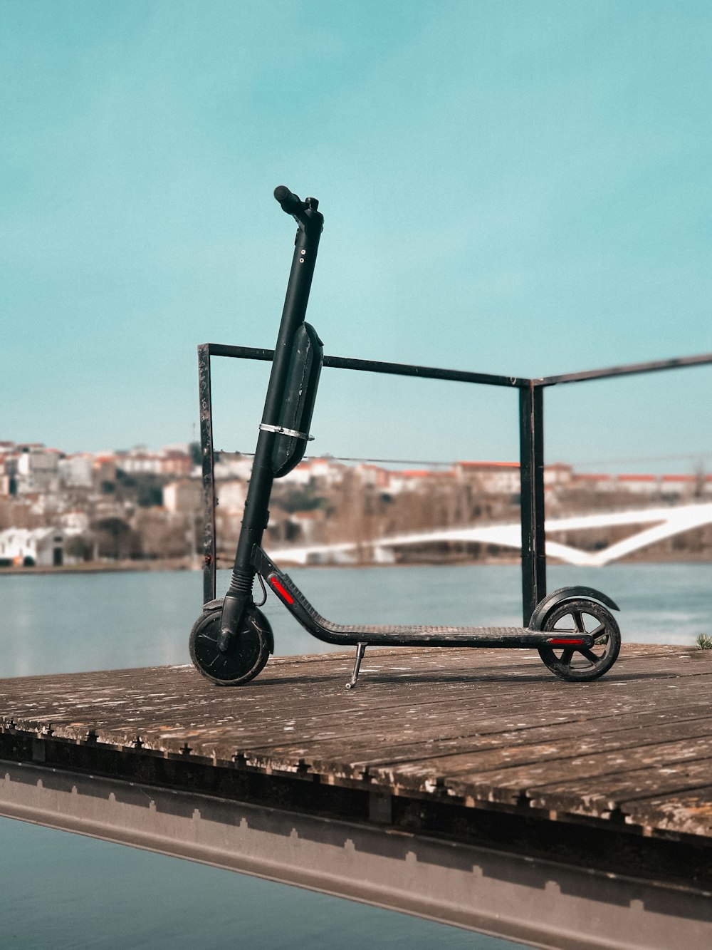 black and gray kick scooter on dock during daytime