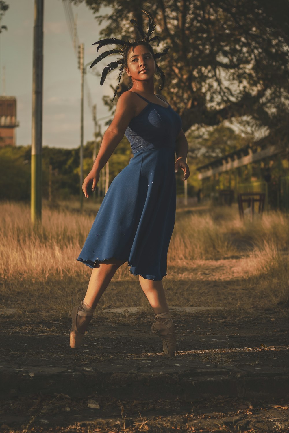 woman in blue dress walking on road during daytime