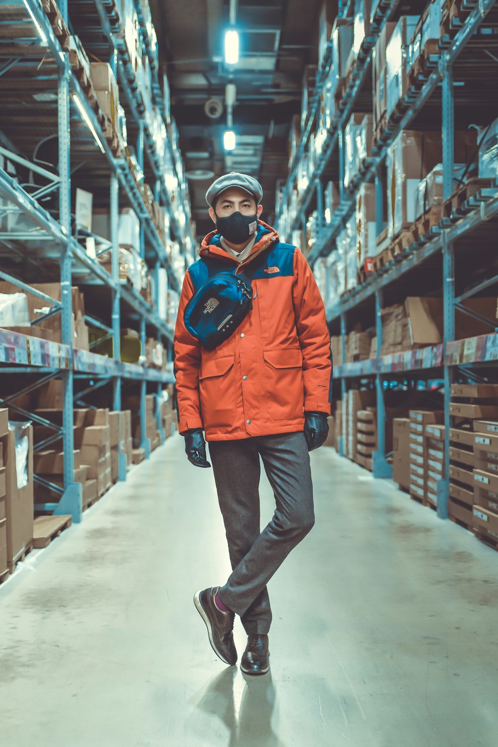 man in red jacket and gray pants wearing blue goggles