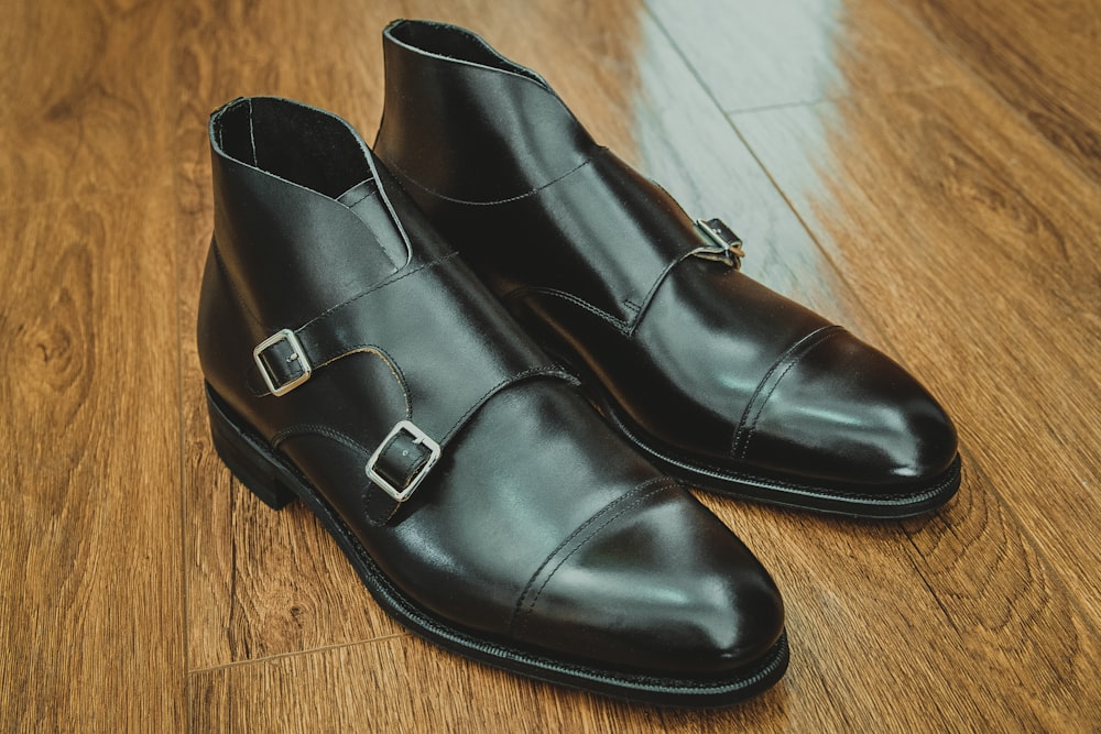 black leather shoes on brown wooden floor