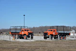 A fleet of orange-accented trucks lined up ready for distribution in Denmark.