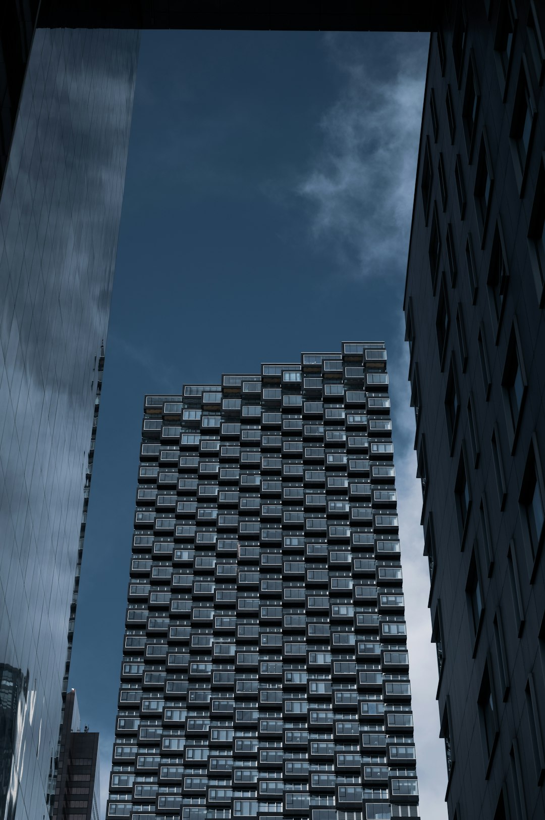 low angle photography of high rise building under blue sky during daytime