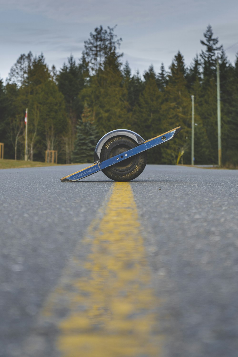 blue and white boat on gray asphalt road during daytime