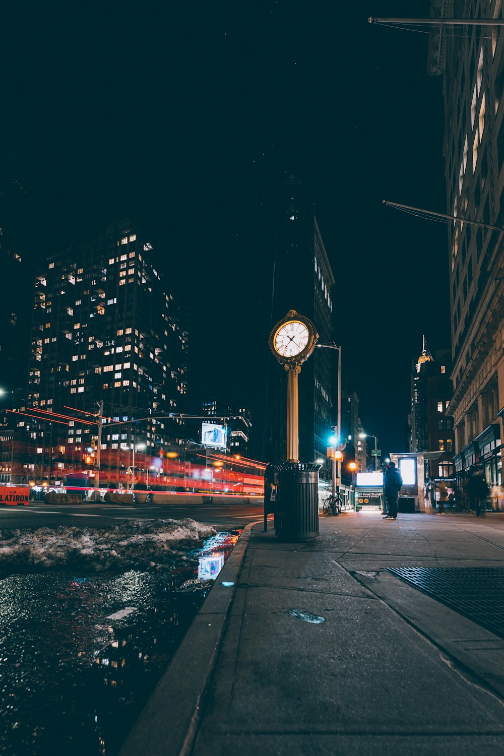 city buildings with street lights during night time