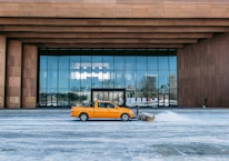 Snow-covered condo entrance with a Ridgecrown Cleaning truck ready for snow removal.