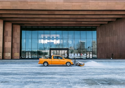 Snow-covered condo entrance with a Ridgecrown Cleaning truck ready for snow removal.