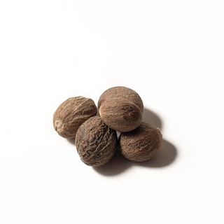 brown almond nut on white surface