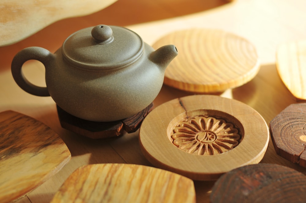 white ceramic teapot on brown wooden round table