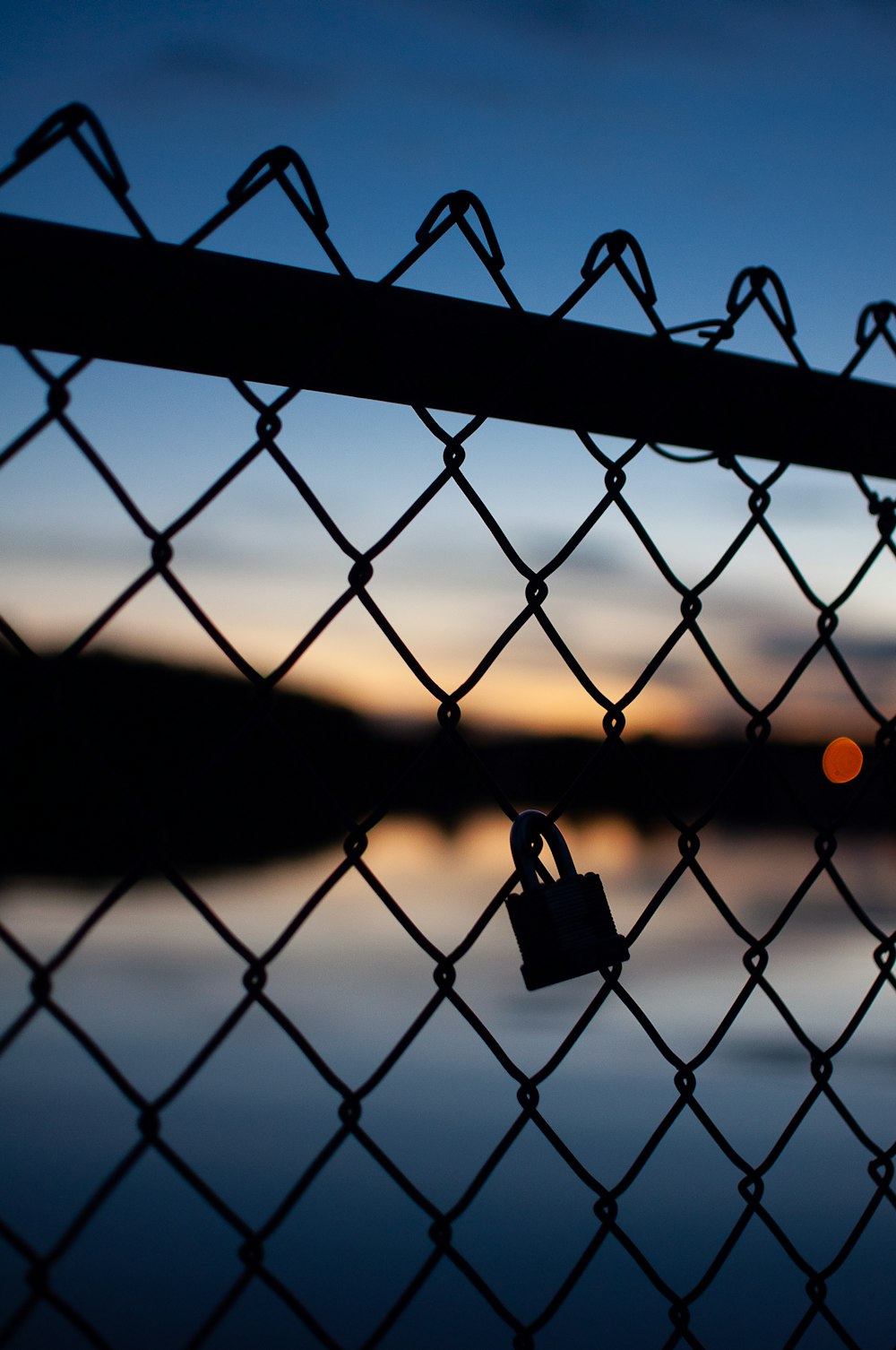 padlock on chain link fence