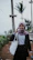 woman in black and white long sleeve shirt holding white paper bag
