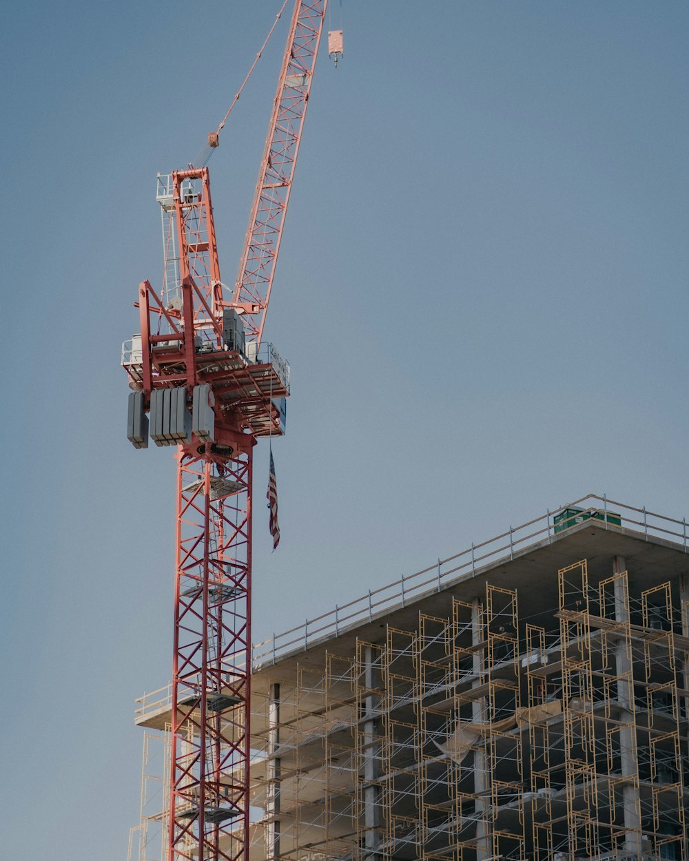 red crane near building during daytime