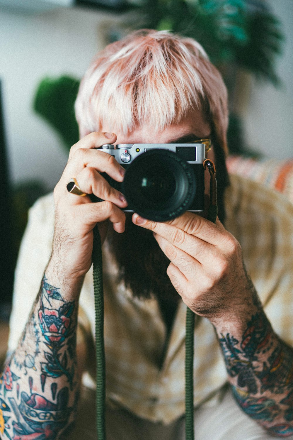 woman in black and white sweater holding black camera