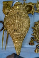 Sacred brass shankh resting on a silk cloth, highlighting its intricate carvings.