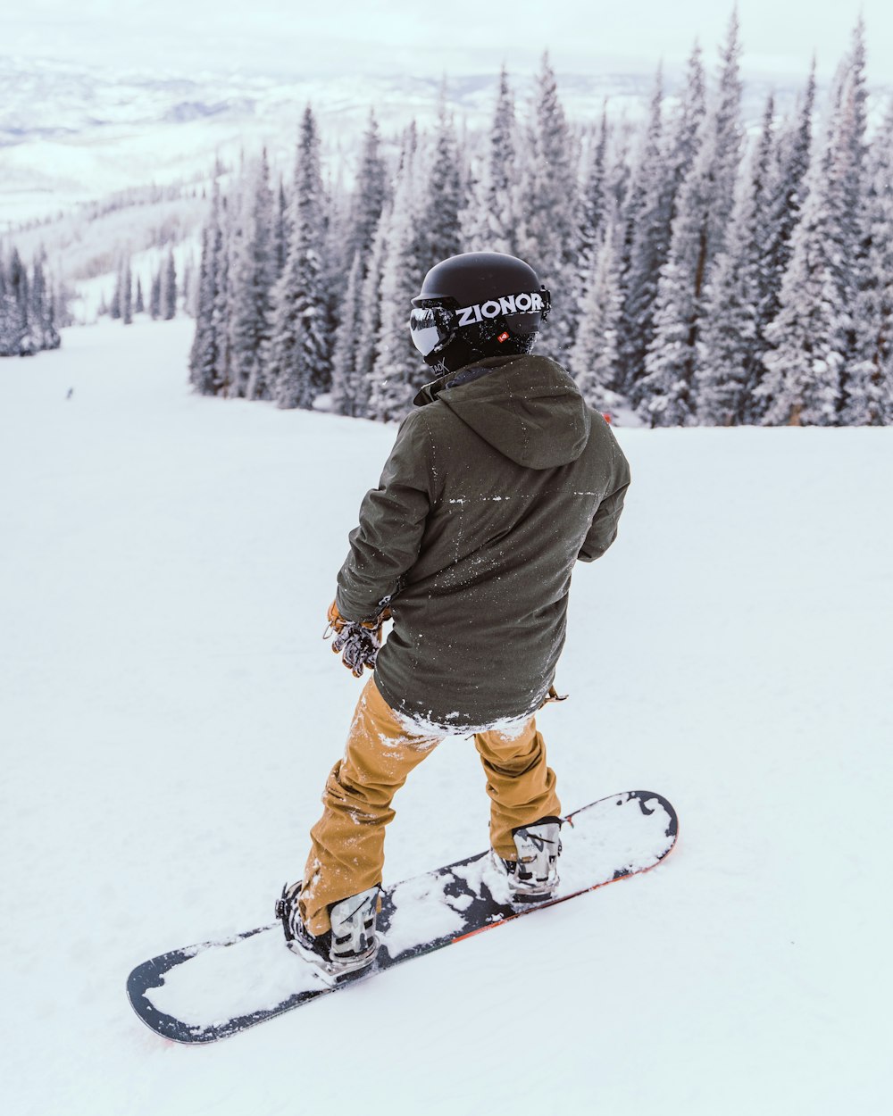 Person in brown jacket and orange pants riding ski blades on snow covered  ground during daytime photo – Free Grey Image on Unsplash