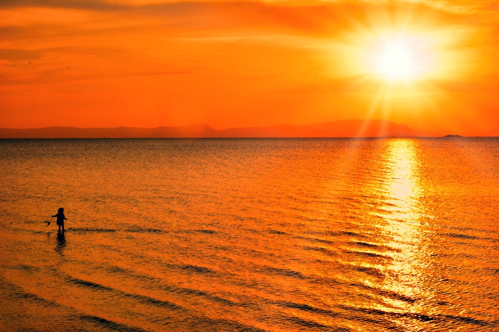 body of water during sunset