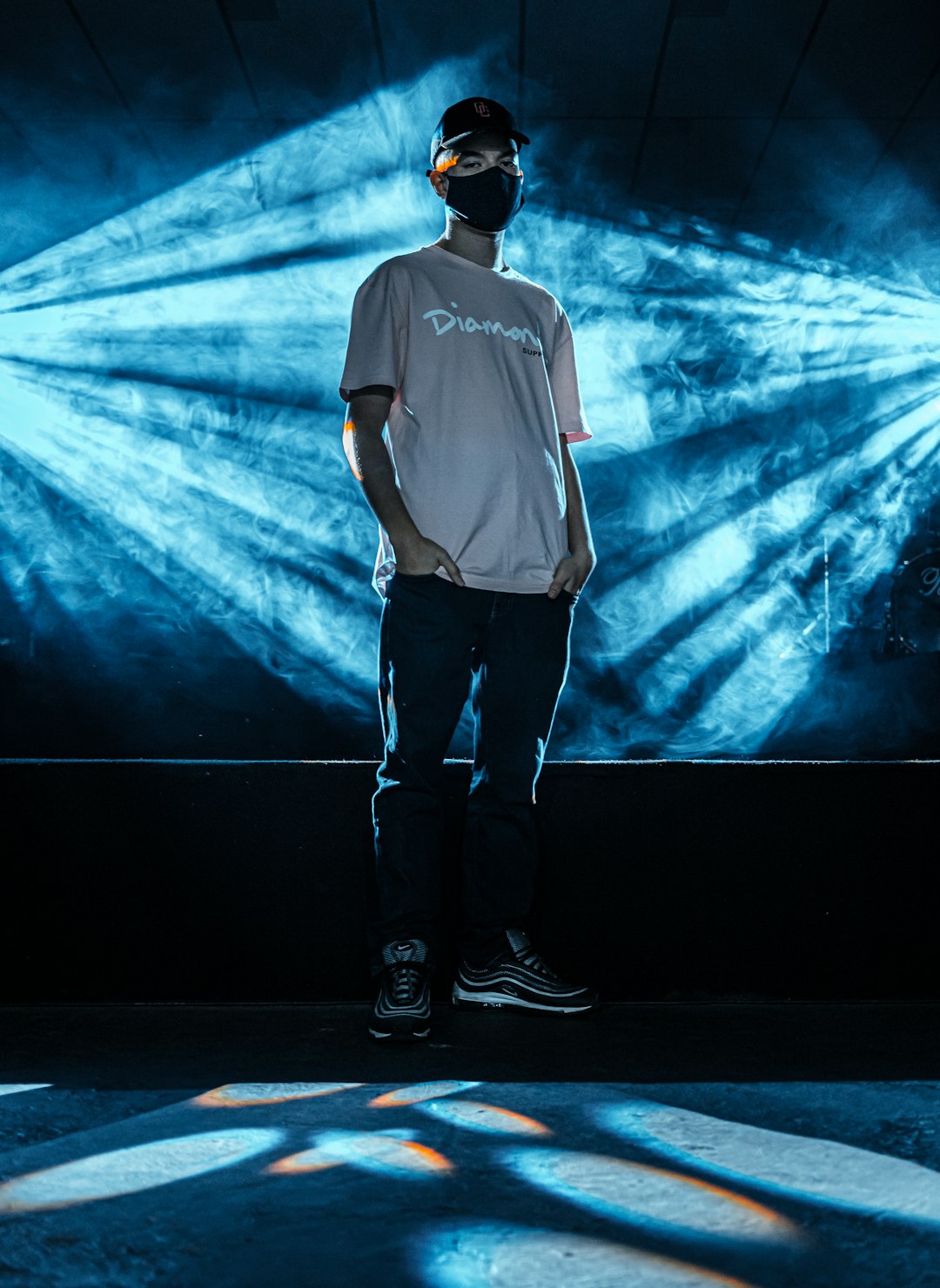 man in white shirt and black pants standing on stage