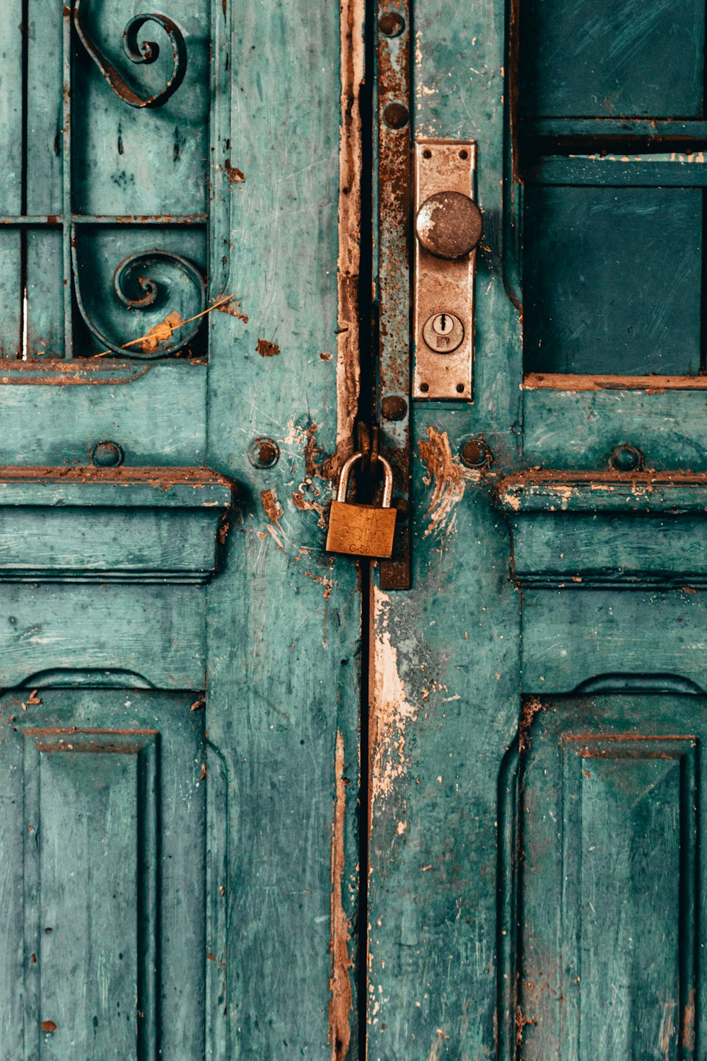 blue wooden door with padlock