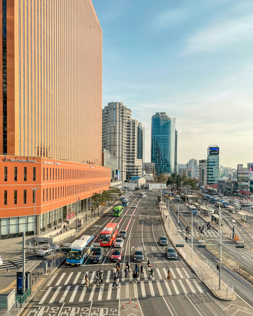 cars on road near high rise buildings during daytime