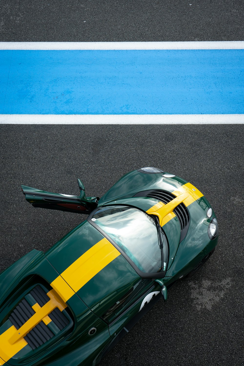 green and yellow car on road