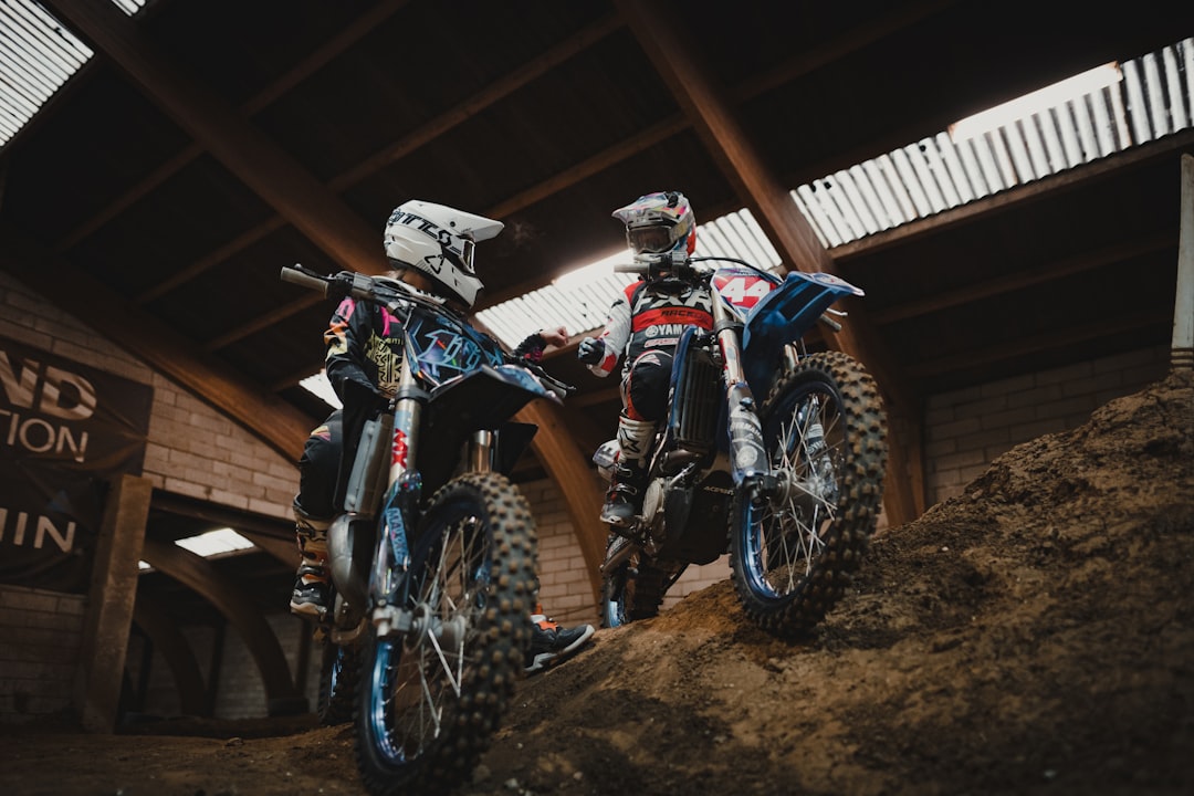 man in blue and white motocross helmet riding blue and white motocross dirt bike