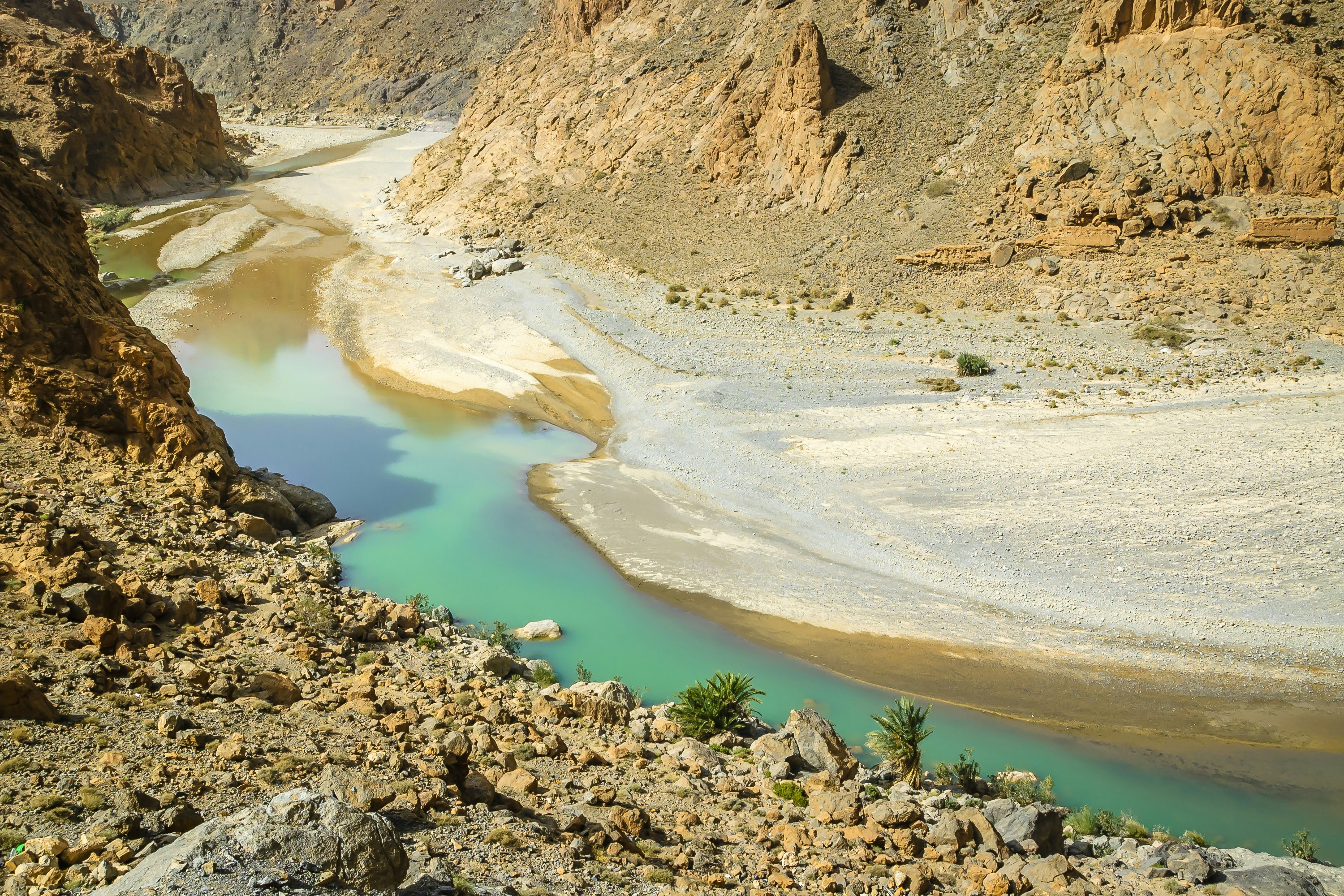 brown rocky mountain near blue lake during daytime, Valley of the Ziz - Morocco