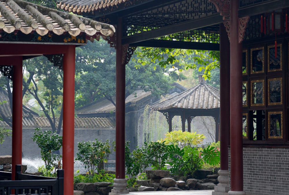 green plants on brown wooden gazebo