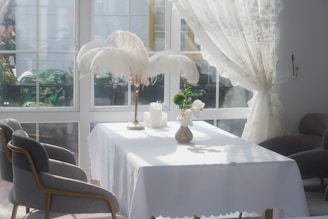 A sunlit room with elegant wedding-themed decor and a view of the garden where the ceremony will be held.