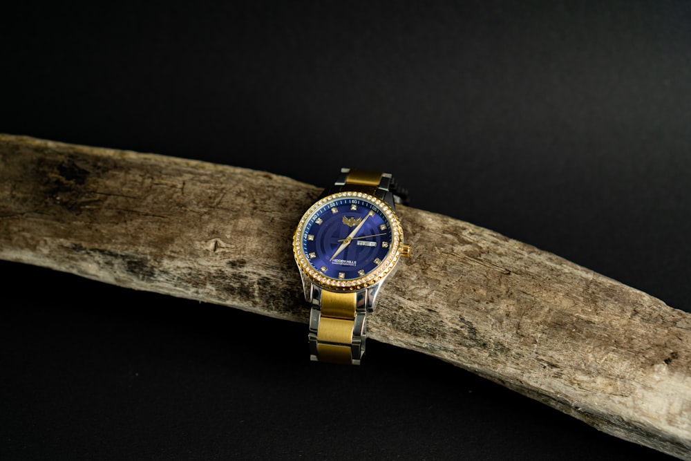 gold and blue analog watch