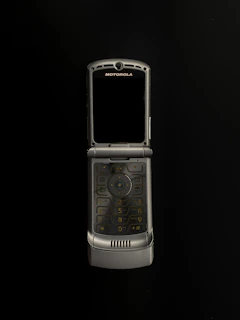 Close-up of a sleek Motorola walkie-talkie glowing softly against a dark background