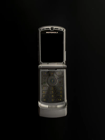 Close-up of a sleek Motorola walkie-talkie glowing softly against a dark background